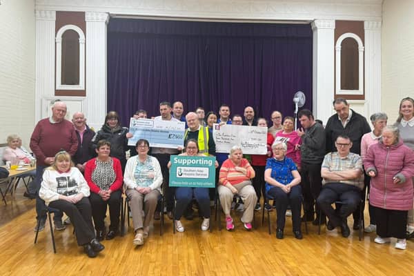 Peter and Conor presenting cheque for £7500 to remembers of The Rainbow Club, Crossmaglen and Southern Area Hospice.