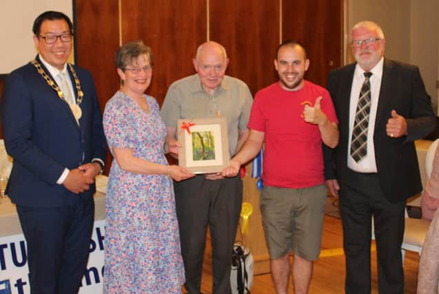 Long standing Newry Show Society member, Brendan Durkin (2nd left) receives a presentation of a framed Nathan Pierson photograph at the recent launch event for Newry Show 2025. Adding their congratulations are: Cllr David Lee-Surginor, former deputy chairman of Newry, Mourne and Down District Council; Tommy Collins, president Newry Agricultural Show Society; Nathan Pierson and Brian Lockhart, chairman of Newry Agricultural Show Society (right)