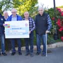 Brian Patterson, left receives a cheque on behalf of Denebtia NI from PJ Quinn, James McPolin, Martin Ward and Dominic McNally of Clonduff Vintage Club.