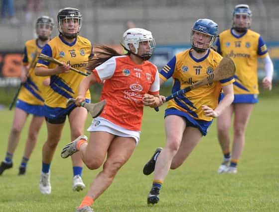 Armagh's Niamh Forker goes past Roscommon's Erin McDermott and Alannah Sutton