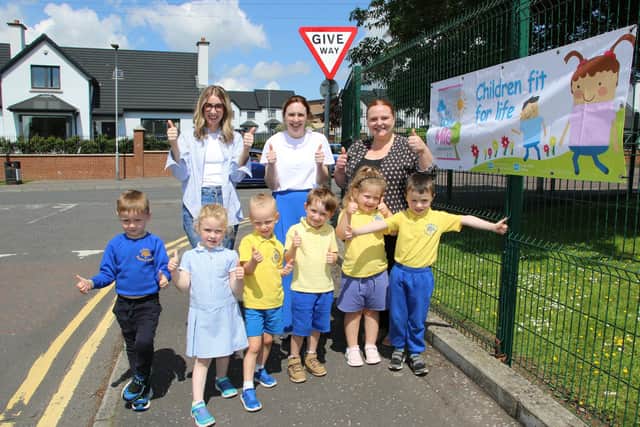 Newry, Mourne and Down District Council Health Inequalities Officer, Alannah Brennan, Southern Health and Social Care Trust Promoting Wellbeing Team Lead Clare Drummy, Ashgrove Nursery School Principal Seona Hamill and pupils enjoying The Daily Mile Walk.