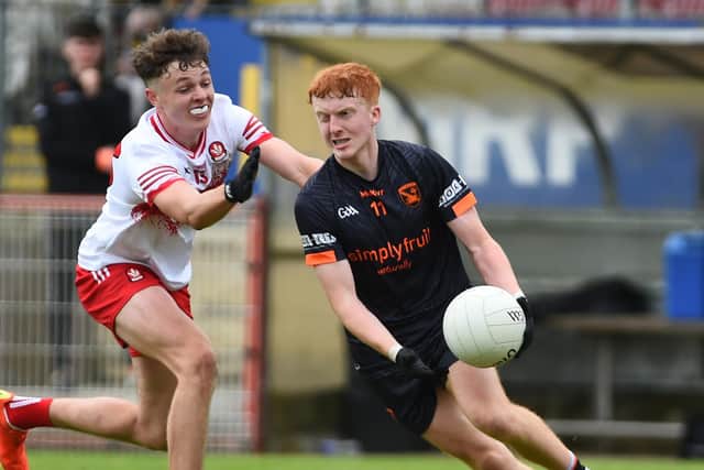 Armagh's James McCooe under pressure from Derry's Chris McCullagh during the Ulster final.