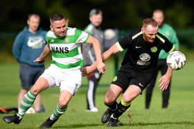 Cleary's Benny Coulter holds off a challenge from hoops attacker Keith Johnston on Satuday at Derrylecka.