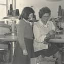 A pupil from Kilkeel Primary School watching one of the employees at the Kilkeel Knitting Mills at work during a school visit to the factory in 1979.