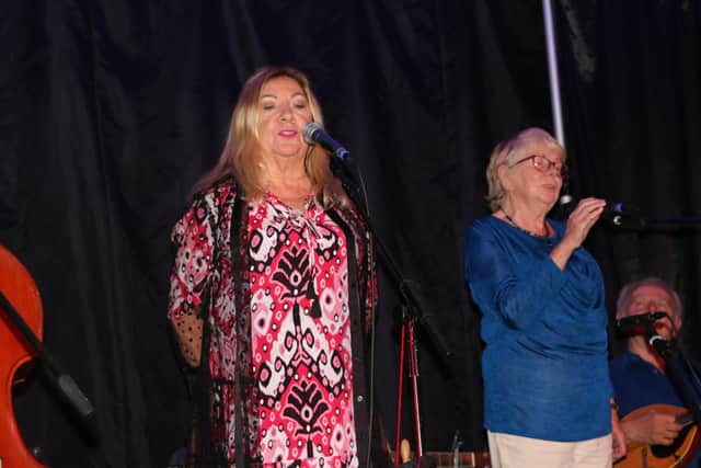 SISTERS - Anne Sands (left) is joined on stage for a song by her sister Mary.