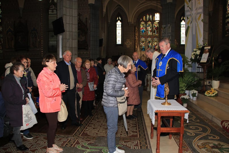 The congregation pray at the Relic to Venerable Matt Talbot in Newry Cathedral after mass and also sign Book of Condolence to Pope Francis. INNR1704