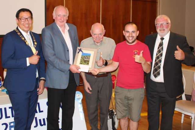 Long standing Newry Show Society member, Brendan Durkin (2nd left) receives a presentation of a framed Nathan Pierson photograph at the recent launch event for Newry Show 2025. Adding their congratulations are: Cllr David Lee-Surginor, former deputy chairman of Newry, Mourne and Down District Council; Tommy Collins, president Newry Agricultural Show Society; Nathan Pierson and Brian Lockhart, chairman of Newry Agricultural Show Society (right)
