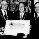 Displaying the Newry City Charter, which was presented to the city in May 2002, are Barry Owens, City Centre Manager; Cllr Frank Feely, vice-chairman of Newry and Mourne Council; Gerard O'Hare, President of Newry Chamber of Commerce and Trade; and Tom McCall, Council Clerk and Chief Executive.