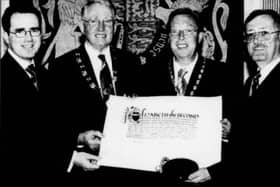 Displaying the Newry City Charter, which was presented to the city in May 2002, are Barry Owens, City Centre Manager; Cllr Frank Feely, vice-chairman of Newry and Mourne Council; Gerard O'Hare, President of Newry Chamber of Commerce and Trade; and Tom McCall, Council Clerk and Chief Executive.
