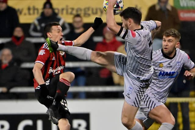 Newry City's Darren King reaches the ball ahead of Crusaders winger Paul Heatley in last weekend's 1-1 draw. Picture: Inpho/Stephen Hamilton