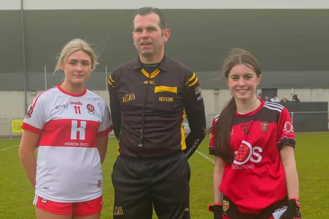 Down U16 captain Orla Owens with the Derry U16 captain and referee Dermot McColgan.