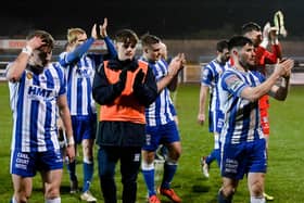 Newry City players applaud the fans.