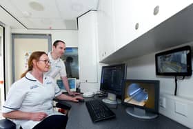 Lee Feenan, Lead General Radiographer and Julia Baltacioglu, MRI Modality Lead Radiographer, at the MRI scanner at Daisy Hill Hospital.