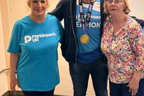 Eamon McConville with his London marathon medal, pictured with Newry Support Group Coordinator Cathy Fegan (left) and his mum Mairin (right).