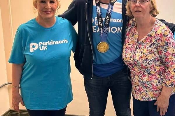 Eamon McConville with his London marathon medal, pictured with Newry Support Group Coordinator Cathy Fegan (left) and his mum Mairin (right).