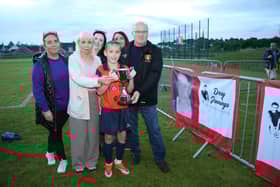 Windmill U11 team captain Ollie Bennett accepts the Kevin Marron Memorial Cup from the Marron family, Mary, Ronnie, Noelle, Kate and Roisin.