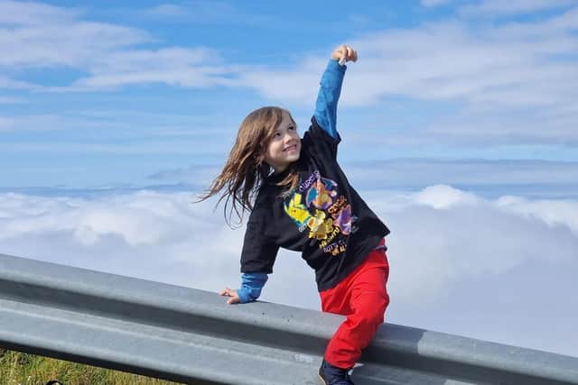 Six-year-old Leon Toase reaches for the sky.