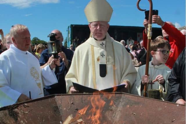 Archbishop Eamon Martin lights the fire at Slane in 2023.