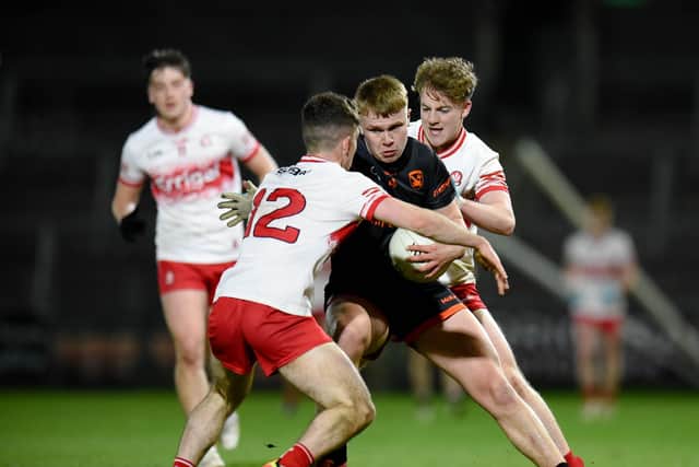 Aaron O'Neill runs into a two-man Derry tackle on Wednesday night in the Ulster U20 Championship.