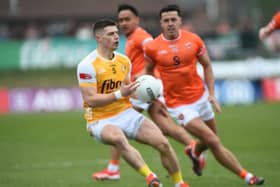 Armagh's Stefan Campbell goes in for a tackle against Antrim's James McAuley.