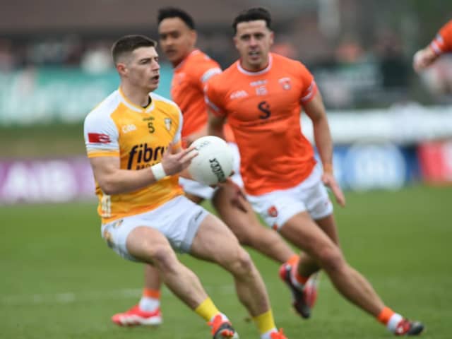 Armagh's Stefan Campbell goes in for a tackle against Antrim's James McAuley.
