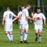 Orchard United players celebrate a goal.
