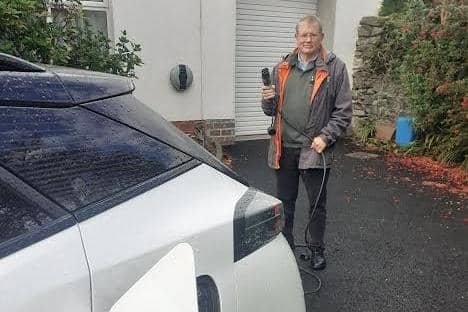 Cllr Cadogan Enright charging his electric vehicle.