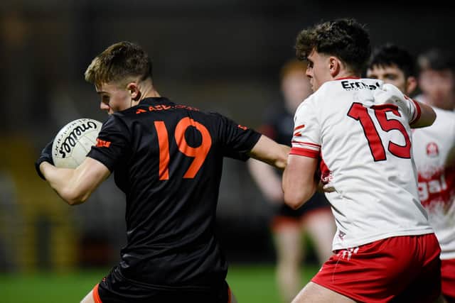 Derry's Oisin Doherty gets a grip on Armagh substitute Eugene McEntee.