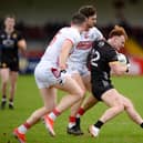 Danny Magill finds a gap in the Cork defence during the league. Had Cork lost on Sunday Down would have remained in Division 2.