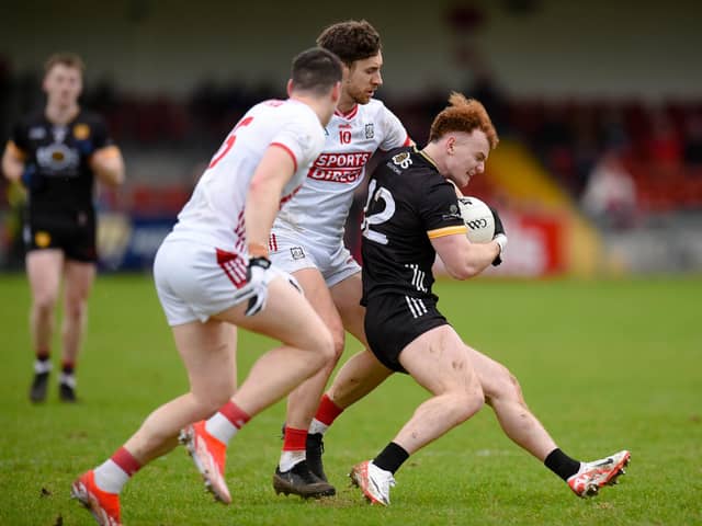 Danny Magill finds a gap in the Cork defence during the league. Had Cork lost on Sunday Down would have remained in Division 2.