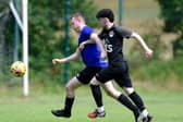 Millburn defender Thomas Beggs gets away from Rossowen's Ciaran Monaghan on Saturday.