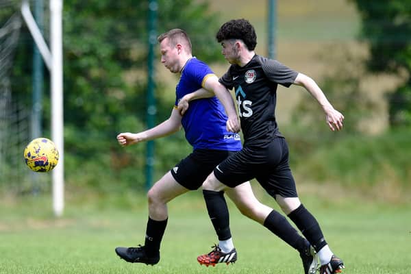 Millburn defender Thomas Beggs gets away from Rossowen's Ciaran Monaghan on Saturday.