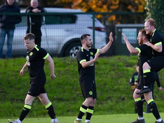 Cleary Celtic players Mark Hughes and Cathal O'Reilly congratulate first half goal scorer Brendan Coulter on Saturday.