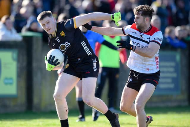 Down midfielder Odhran Murdock shrugs off a challenge from Louth's Dermott Campbell when the sides met in the National League.