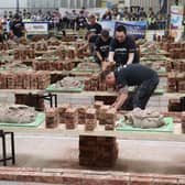 Contestants in action, observed closely by judges and spectators.