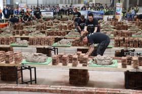 Contestants in action, observed closely by judges and spectators.