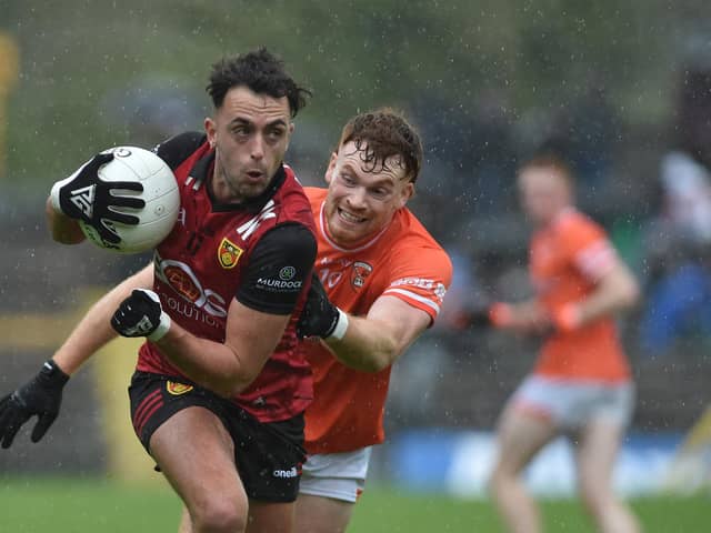 Down's Ryan Johnston looks to escape the clutches of Armagh's Jason Duffy.