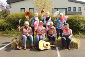 Rathfriland WI committee members get in gear for the Wild West Barn Dance: (l-r) Margot Groves, Janice Bell, Ada Elliott, Stella Shilliday (seated) and (standing) Susan Scott, Caroline McCreight and Noreen Smith