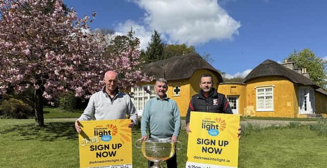 Declan Murphy (Camlough Community Association), Seamus McCabe (CEO, PIPS Hope & Support), Eamonn McCann (Craobh Rua Camlocha Hurling Club) pictured at Derramore House with the Sam Maguire.