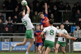 Burren midfielder Dylan Kelly wins the aerial battle with Ardboe's Luke Muldoon.