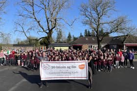 Staff and pupils at Gaelscoil Phádraig Naofa celebrating 20 years.