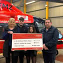 Members of the Nummy family make a contribution of £19,928 to Air Ambulance NI.