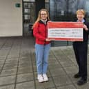 Amy Henshaw (Air Ambulance NI) receiving a cheque for £1072 from Bridgeen Torrens (Translink).