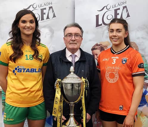 Armagh captain Clodagh McCambridge and Donegal's Susanne White with Ulster LGFA President Gerry Doherty