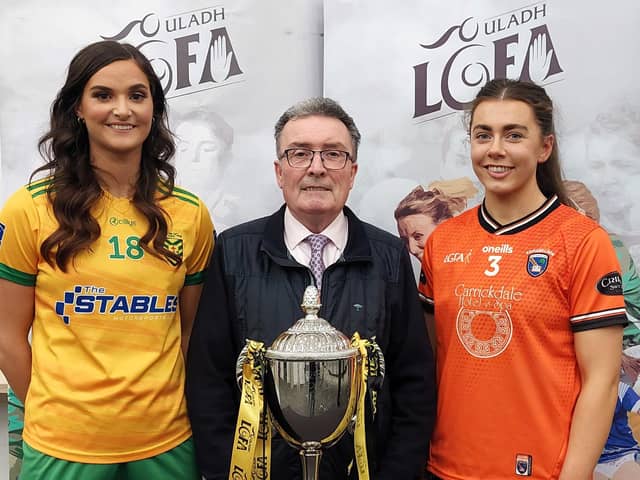 Armagh captain Clodagh McCambridge and Donegal's Susanne White with Ulster LGFA President Gerry Doherty