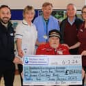 John Dalzell OBE presents a cheque for £125,467.60 to staff from Southern Area Hospice. The donation is the proceeds raised during John’s 32nd annual Christmas sit-out in Newry in December 2023 and collections by his dedicated Fiveways and Damolly teams. John and his team have raised £2.25 million for Southern Area Hospice to date. Pictured are: John Dalzell OBE (centre) and left to right, James McCaffrey, Fundraising Officer; Mary Armstrong, Specialist Physiotherapist; Dr Osmond Morris, Lead Consultant; Damien Hillen, Director of Development; and Louise Stewart, Interim Inpatient Services Manager from Southern Area Hospice. INNR0600