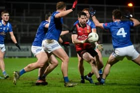 Down's James Guinness finds himself surrounded by Cavan Players at Pairc Esler during their recent Dr McKenna Cup clash.