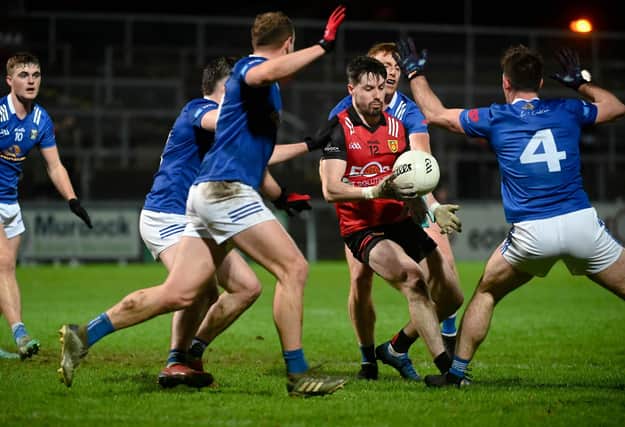 Down's James Guinness finds himself surrounded by Cavan Players at Pairc Esler during their recent Dr McKenna Cup clash.