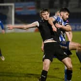 Newry City's Darren King battles with Ballymena United's Noah Stewart during their game in December.