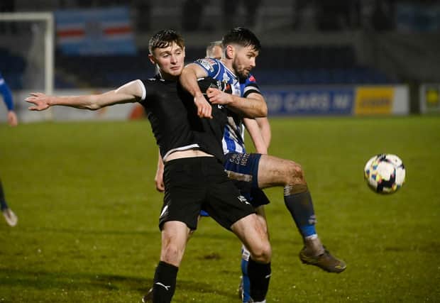 Newry City's Darren King battles with Ballymena United's Noah Stewart during their game in December.